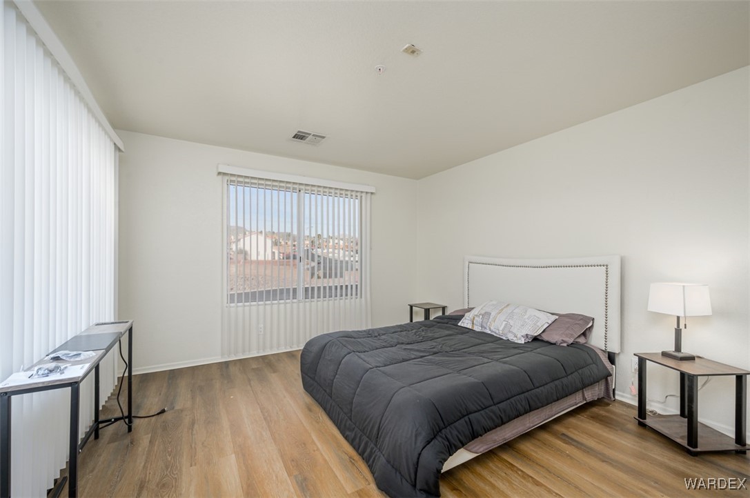 2004 Mesquite Lane, Unit 304 Laughlin, NV 89029 - Photo 20 of 36 a bedroom with a bed and wooden floor
