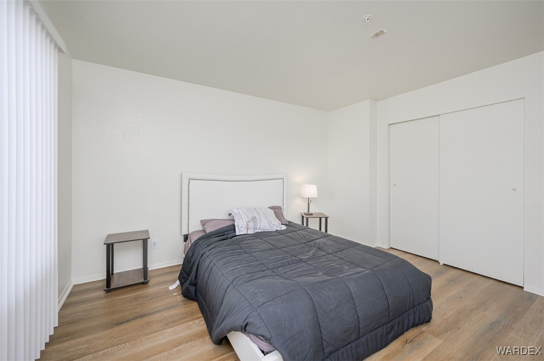 2004 Mesquite Lane, Unit 304 Laughlin, NV 89029 - Photo 22 of 36 a bedroom with a bed and a night stand