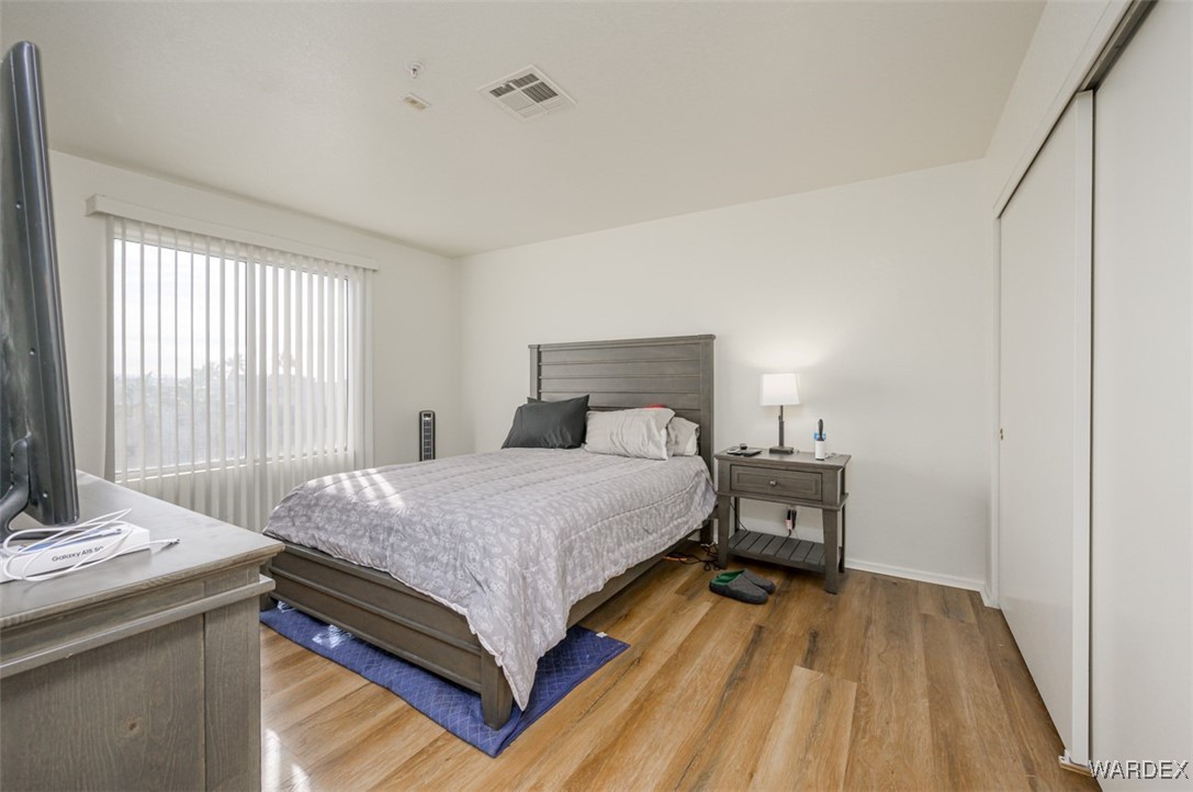2004 Mesquite Lane, Unit 304 Laughlin, NV 89029 - Photo 25 of 36 a bedroom with a bed and wooden floor