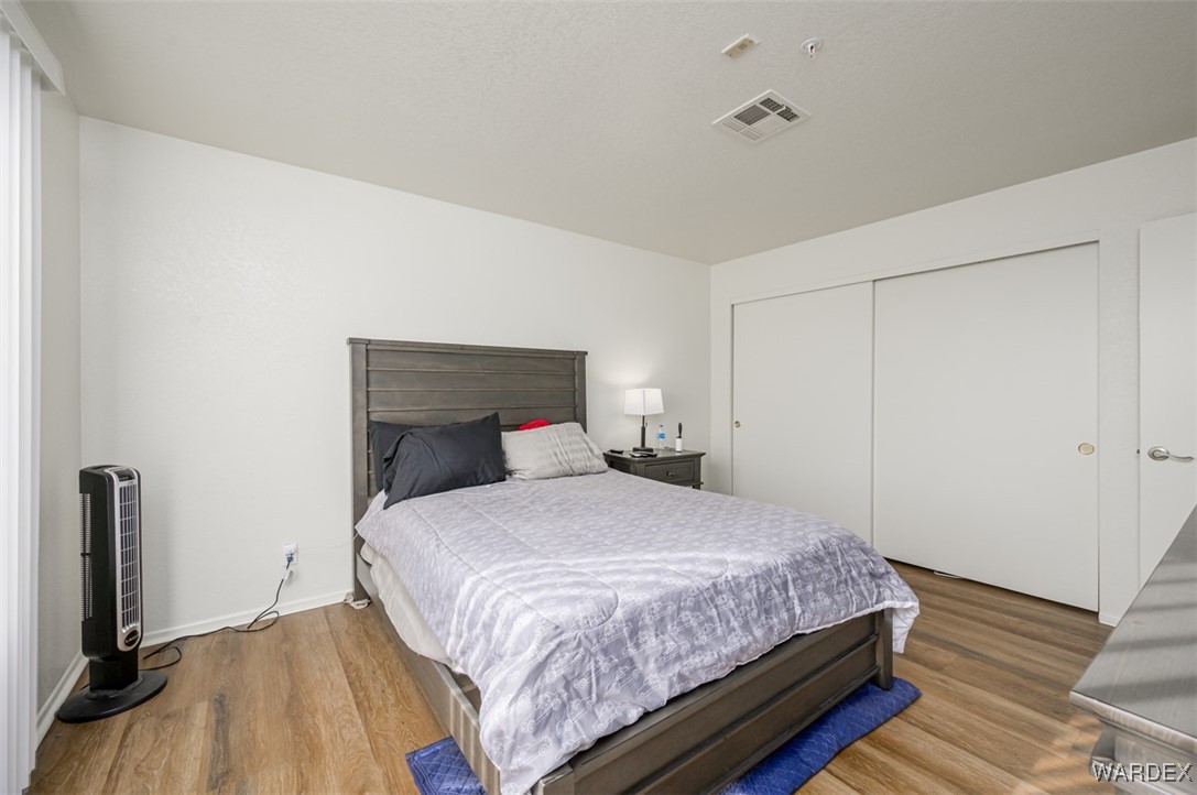 2004 Mesquite Lane, Unit 304 Laughlin, NV 89029 - Photo 28 of 36 a bedroom with a bed and wooden floor