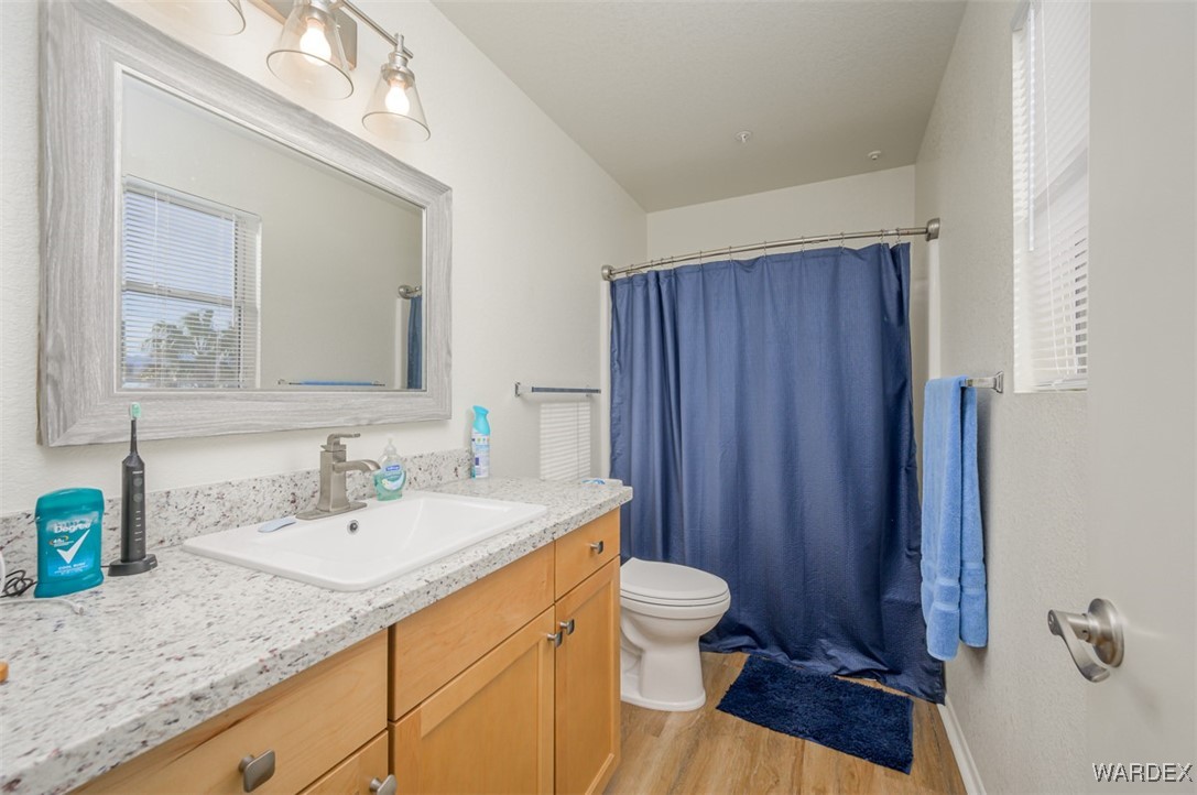 2004 Mesquite Lane, Unit 304 Laughlin, NV 89029 - Photo 29 of 36 a bathroom with a granite countertop sink toilet and mirror