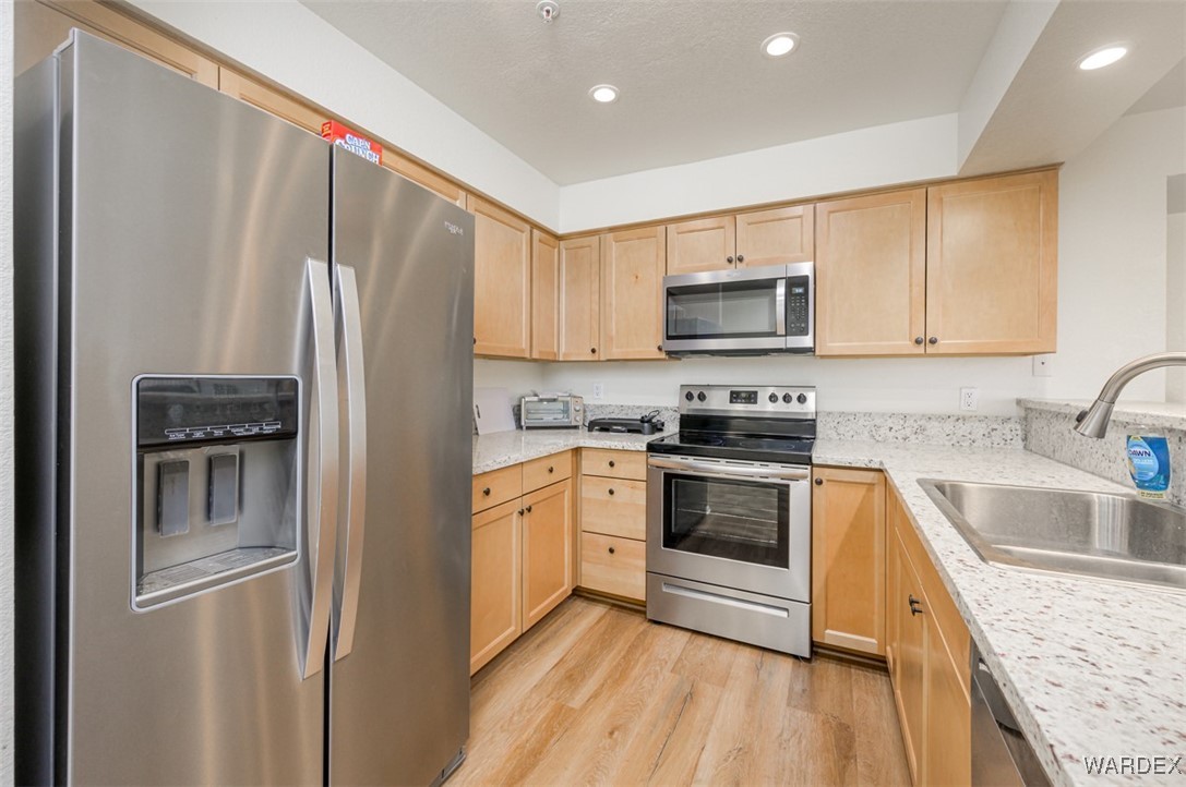 2004 Mesquite Lane, Unit 304 Laughlin, NV 89029 - Photo 4 of 36 a kitchen with granite countertop a refrigerator stove and sink