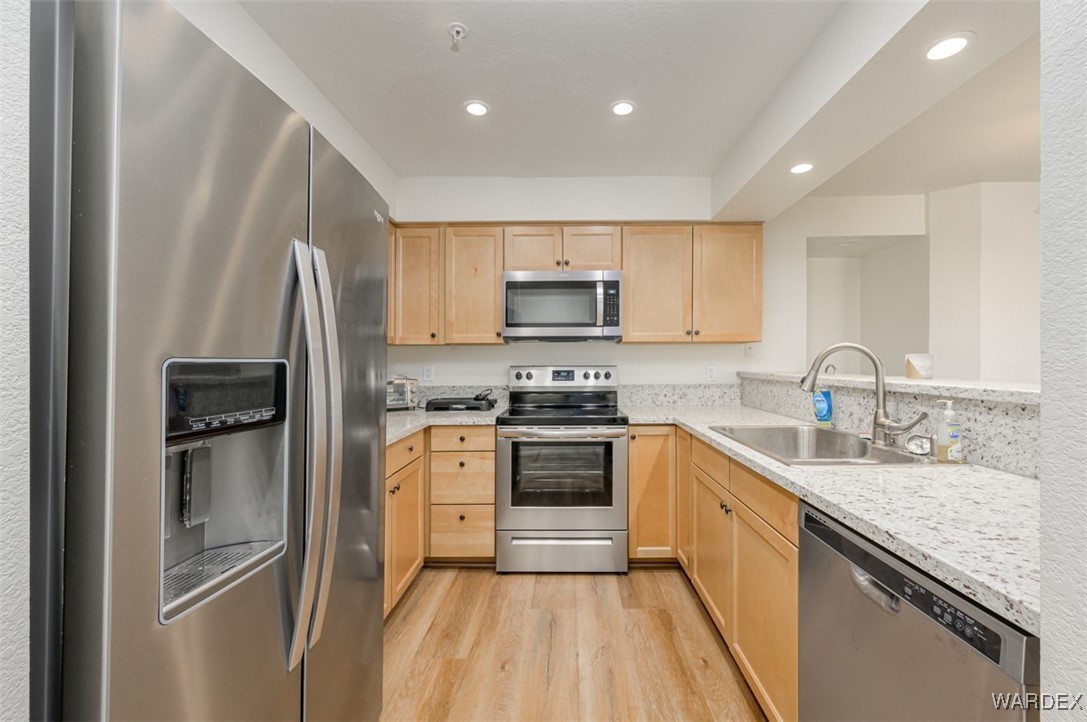2004 Mesquite Lane, Unit 304 Laughlin, NV 89029 - Photo 5 of 36 a kitchen with stainless steel appliances granite countertop a refrigerator sink and stove
