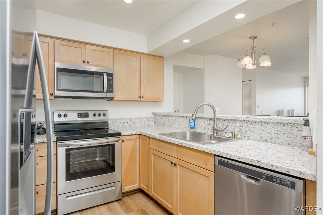 2004 Mesquite Lane, Unit 304 Laughlin, NV 89029 - Photo 6 of 36 a kitchen with sink cabinets and stainless steel appliances