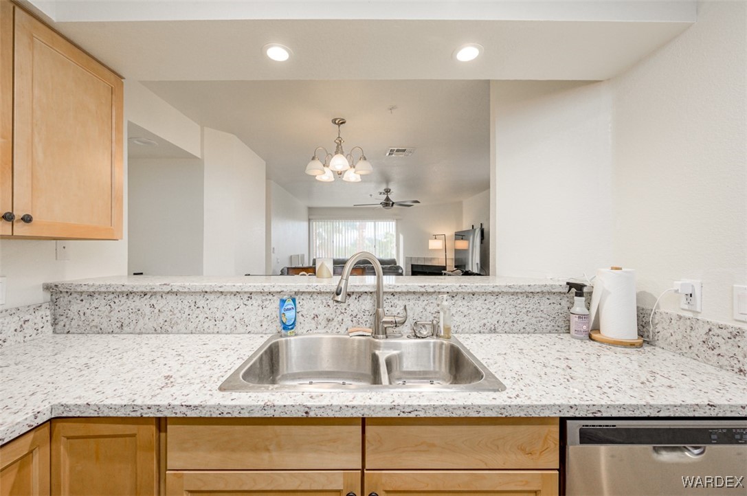 2004 Mesquite Lane, Unit 304 Laughlin, NV 89029 - Photo 8 of 36 a kitchen with granite countertop a sink and cabinets