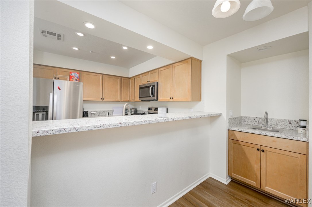 2004 Mesquite Lane, Unit 304 Laughlin, NV 89029 - Photo 9 of 36 a large kitchen with granite countertop a sink stainless steel appliances and cabinets