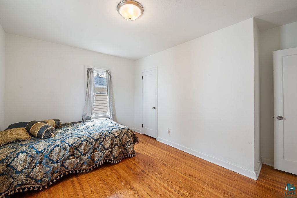122 3rd Street Cloquet, MN 55720 - Photo 17 of 42 Hardwood flooring complementing white walls and trim