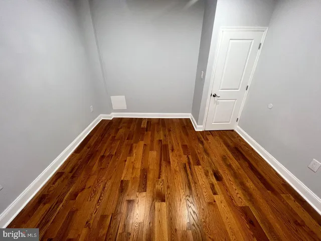 a view of room with wooden floor
