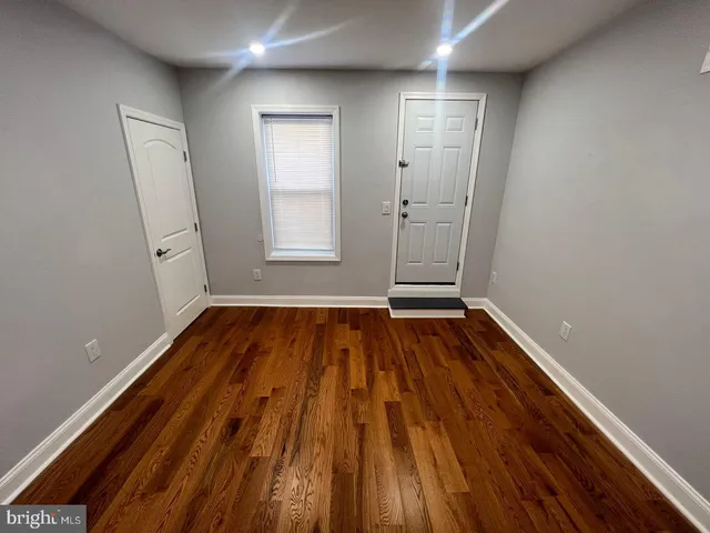 a view of room with window and hardwood floor