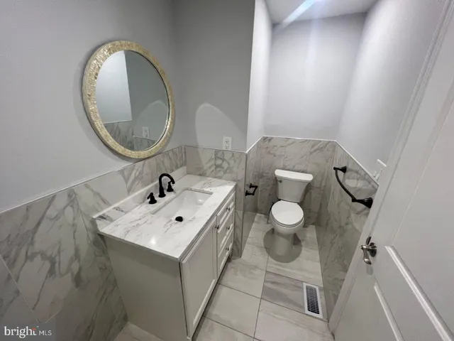 a bathroom with a sink a vanity and a mirror