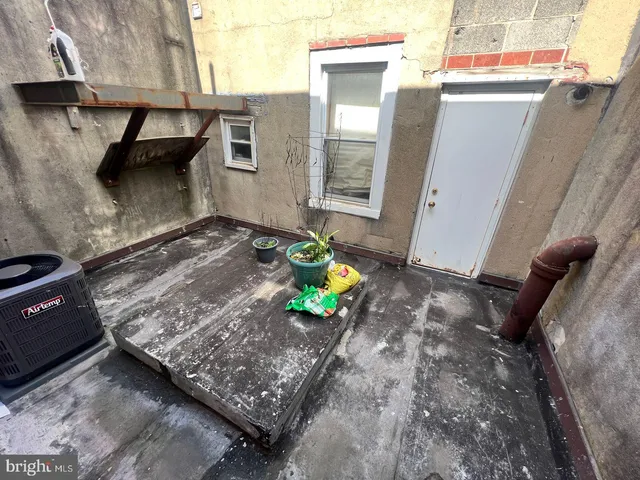 a building outdoor space with a barbeque and trees