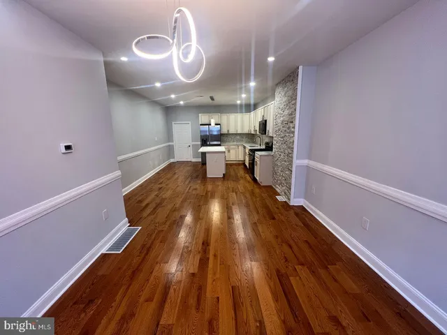 a view of a living room and wooden floor