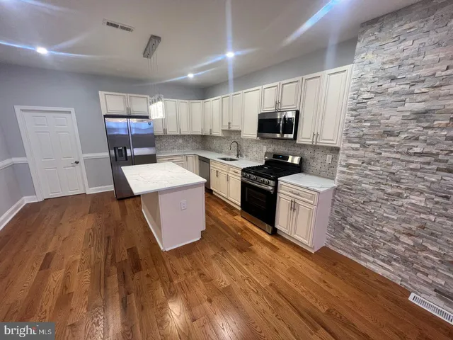a kitchen with a sink and a stove top oven