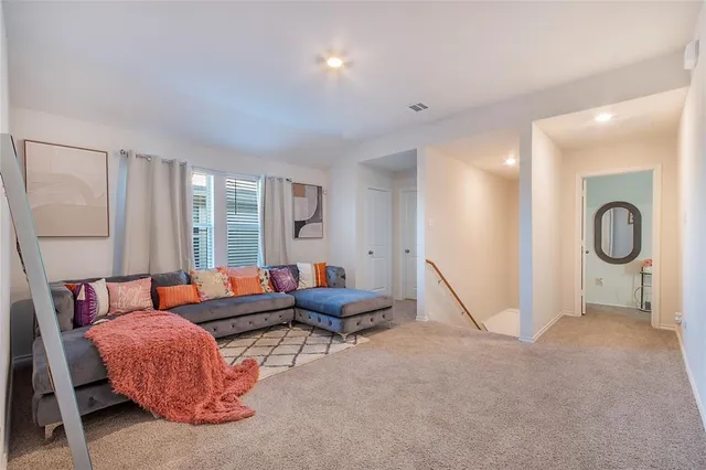 a living room with furniture and a floor to ceiling window