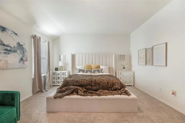 a bedroom with a bed and a couch