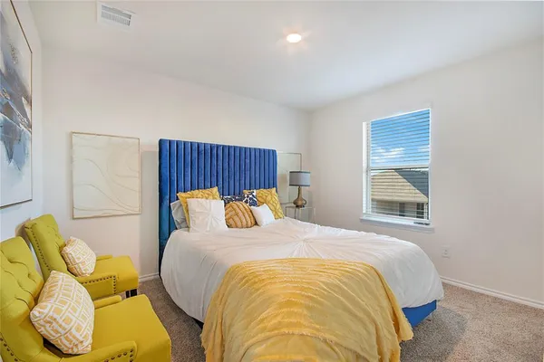 a bedroom with a bed and window