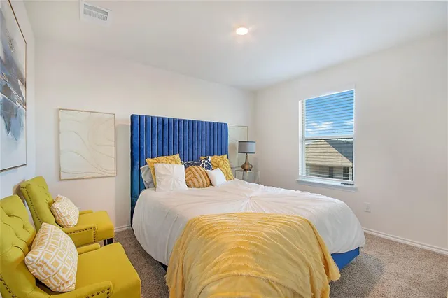 a bedroom with a bed and window