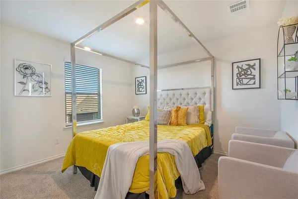 a bedroom with a bed and a couch