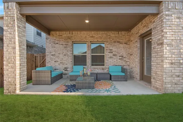 a view of a patio with couches chairs and a yard