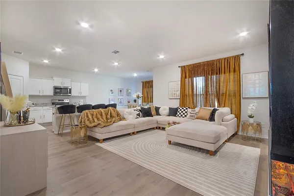 a living room with furniture and a large window