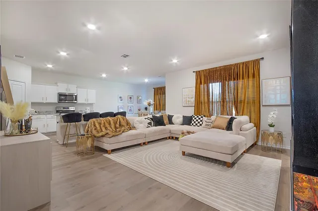 a living room with furniture and a large window
