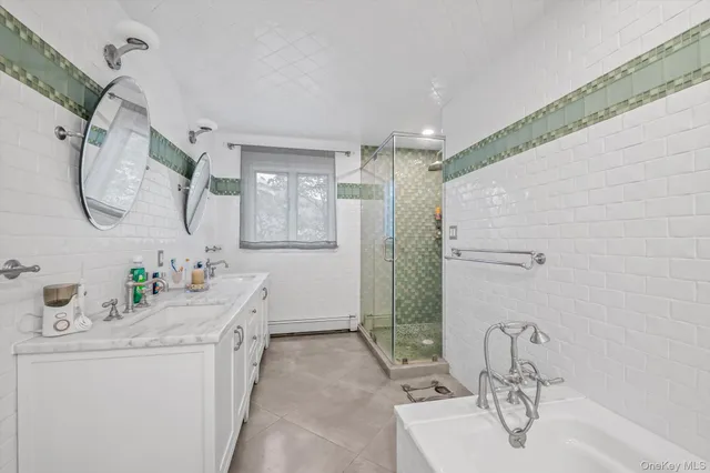 a bathroom with a double vanity sink mirror and shower