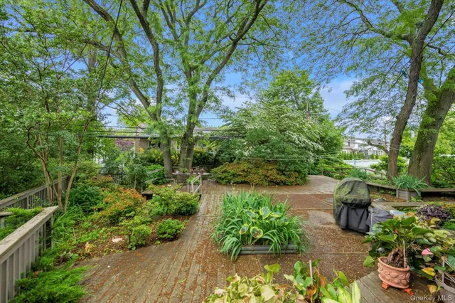 a backyard of a house with a garden and outdoor seating