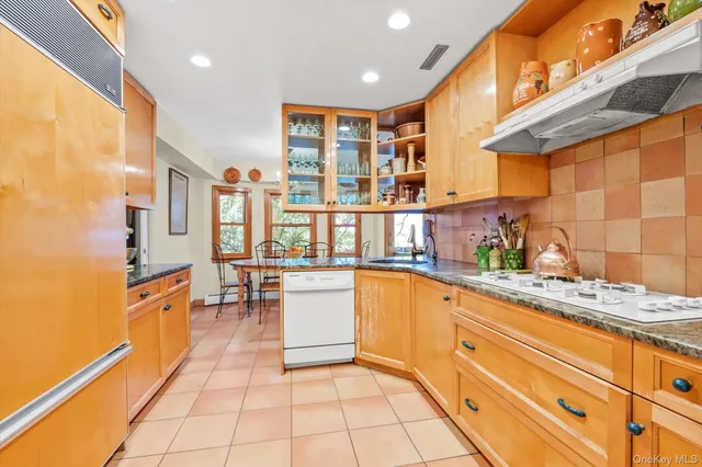 a kitchen with stainless steel appliances granite countertop a sink and cabinets