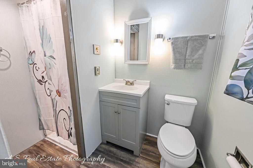 30833 Dogwood Drive Laurel, DE 19956 - Photo 17 of 27 a bathroom with a toilet sink vanity and mirror