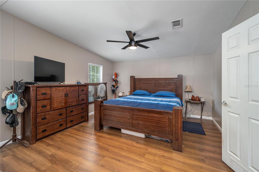 15079 Brahma Road Polk City, FL 33868 - Photo 8 of 40 a bedroom with furniture and flat screen tv