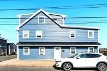 a front view of a house with parking space