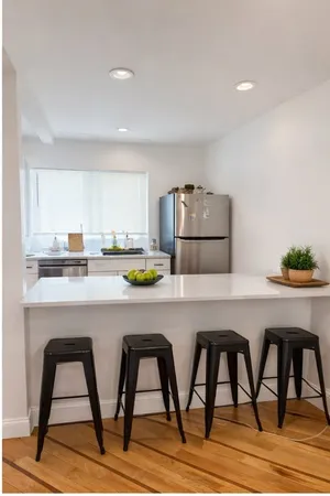 a kitchen with a table chairs sink and microwave