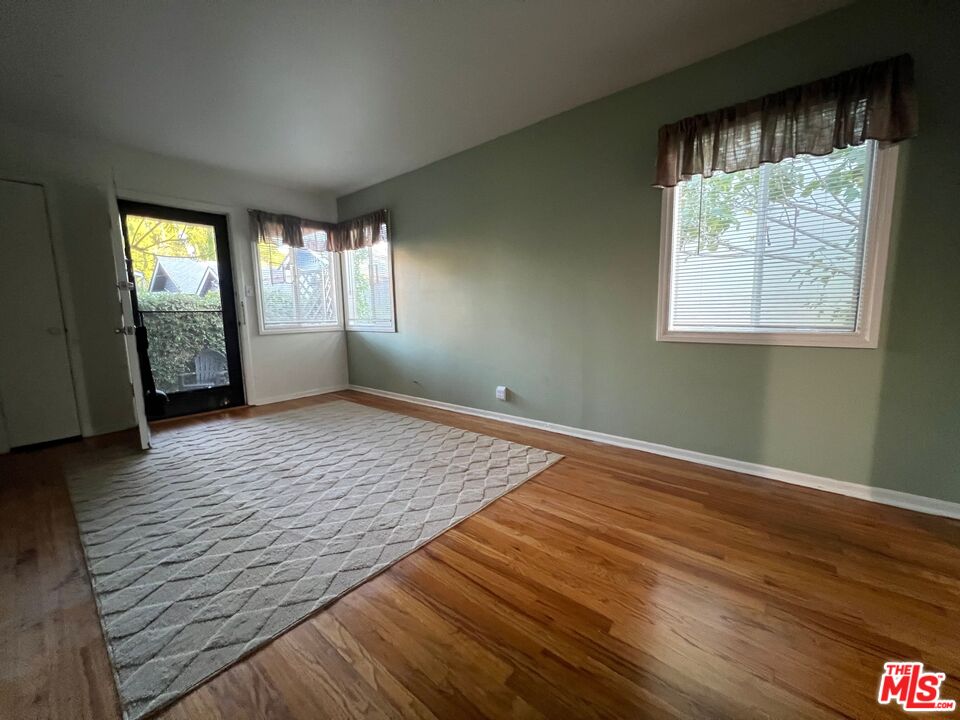 2599 Morningside Street, Unit D Pasadena, CA 91107 - Photo 3 of 13 an empty room with wooden floor and windows
