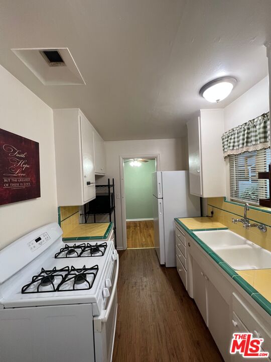 2599 Morningside Street, Unit D Pasadena, CA 91107 - Photo 6 of 13 a kitchen that has a lot of cabinets in it and wooden floors
