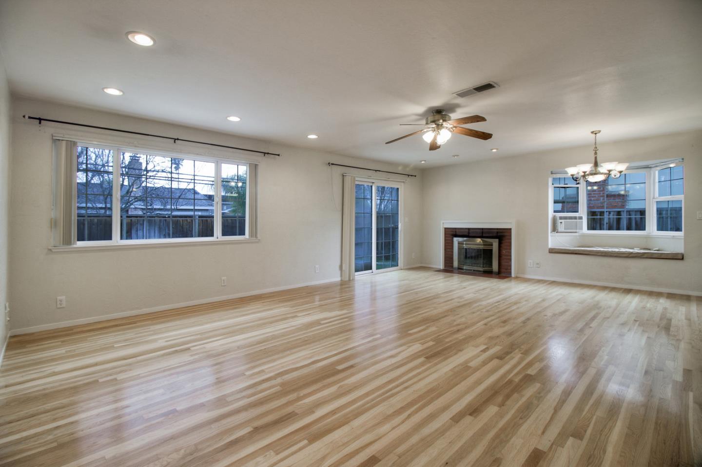 640 Harriet Avenue Campbell, CA 95008 - Photo 3 of 14 a view of an empty room with window and wooden floor