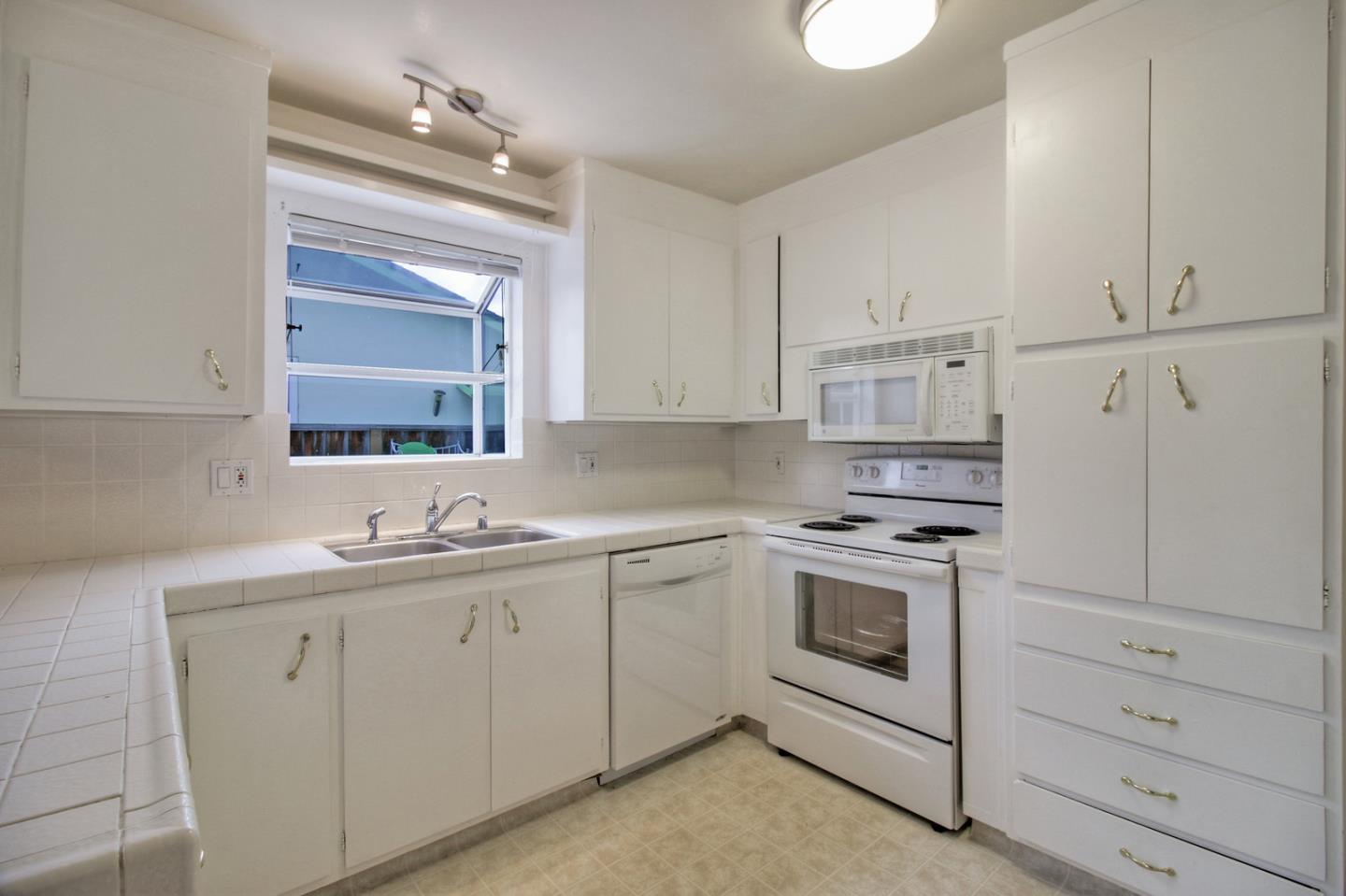 640 Harriet Avenue Campbell, CA 95008 - Photo 4 of 14 a kitchen with white cabinets stainless steel appliances and sink