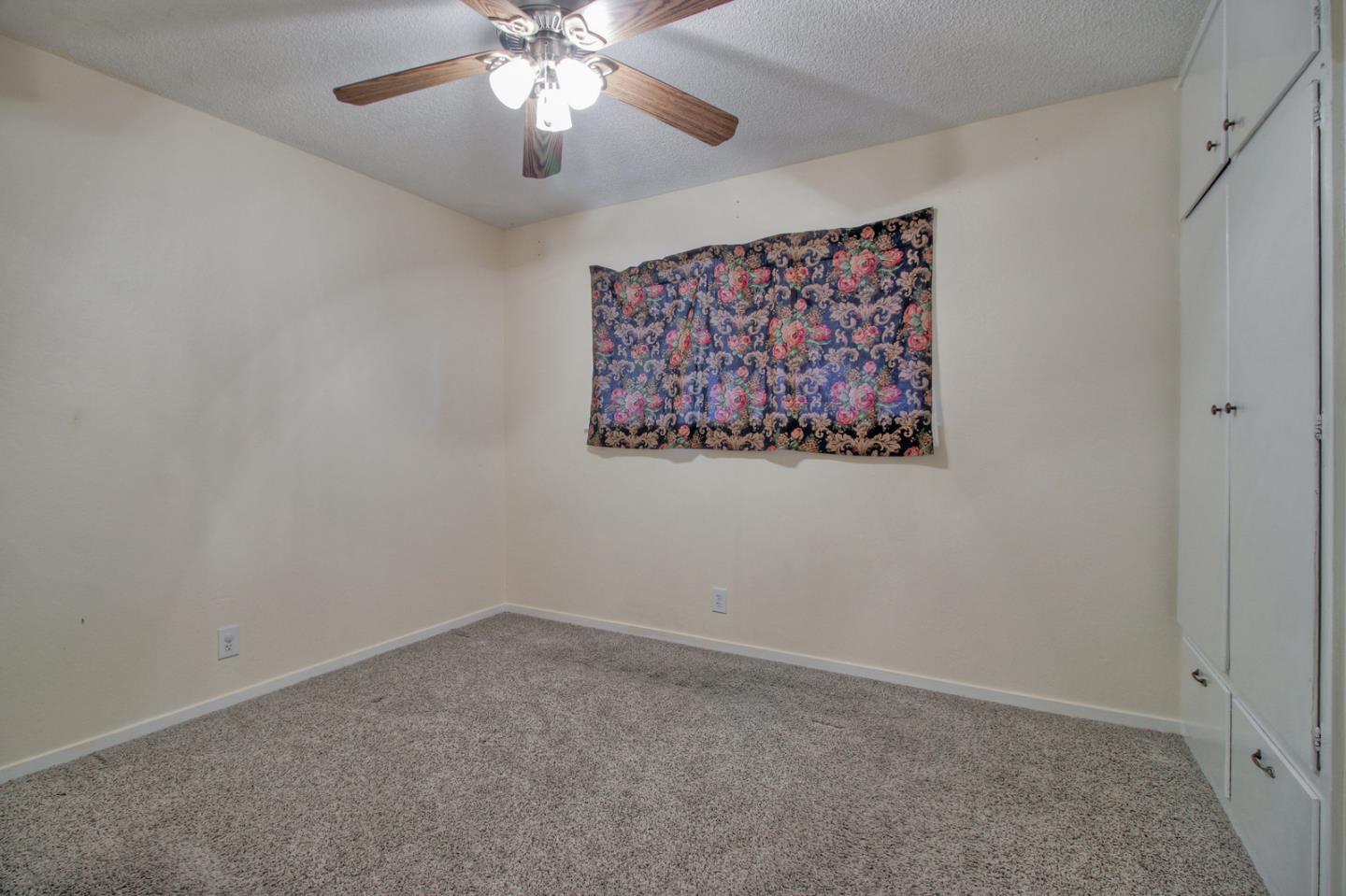 640 Harriet Avenue Campbell, CA 95008 - Photo 9 of 14 an empty room with a chandelier fan