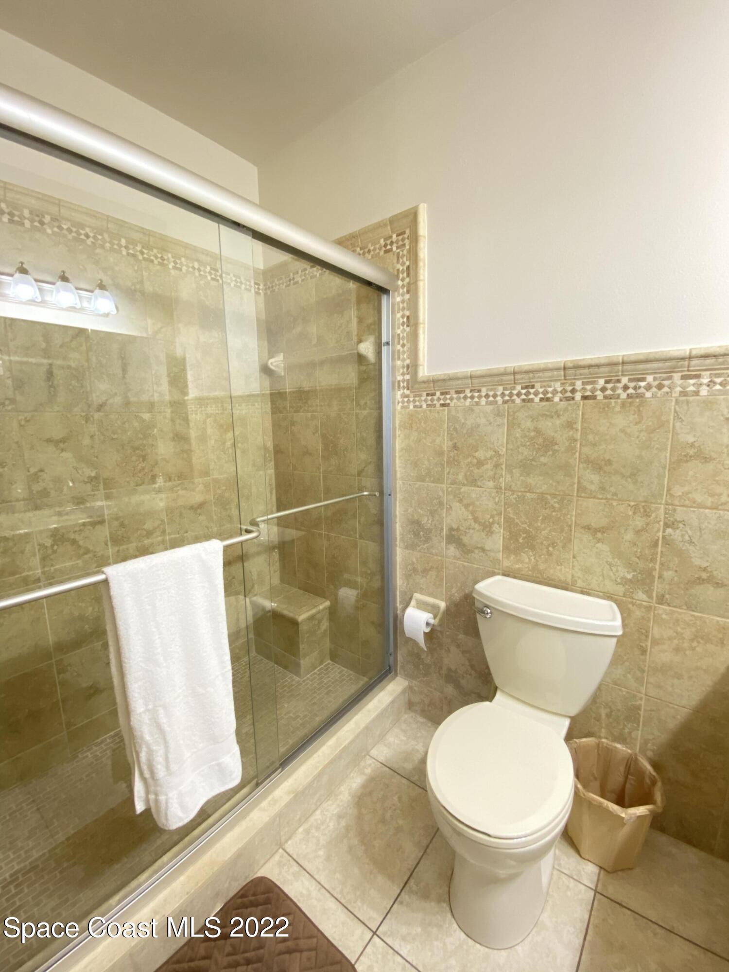 333 North Atlantic Avenue, Unit 305 Cocoa Beach, FL 32931 - Photo 12 of 21 a bathroom with a toilet and a shower