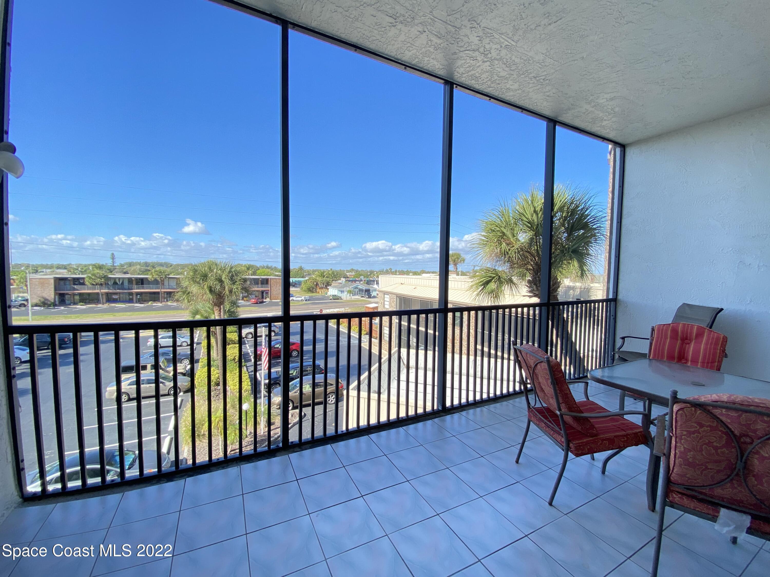333 North Atlantic Avenue, Unit 305 Cocoa Beach, FL 32931 - Photo 17 of 21 a view of a chairs and table in patio