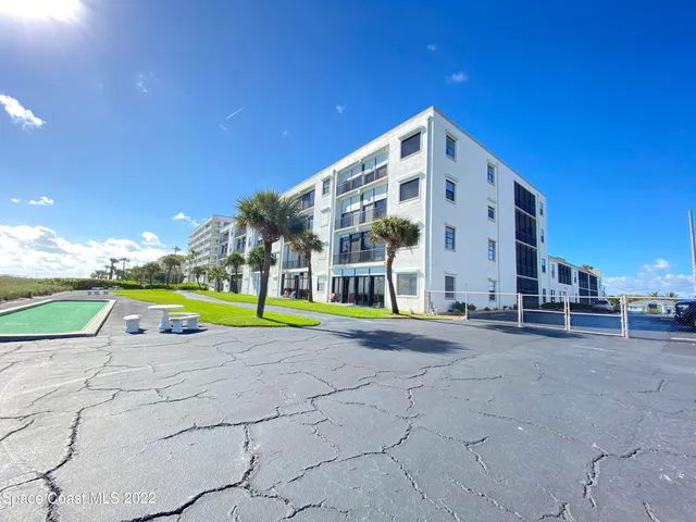 a view of a building with a yard
