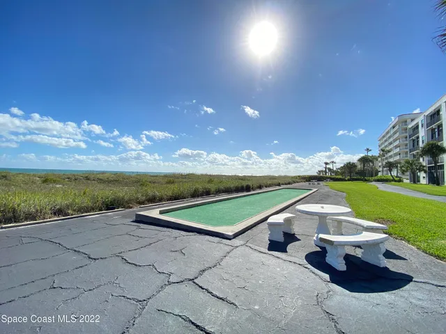 a view of swimming pool with outdoor seating and yard in back