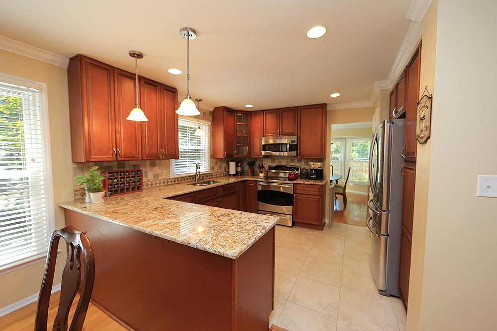 2104 Treverton Place Raleigh, NC 27609 - Photo 5 of 25 WOW...is what you will say when you see this amazing kitchen remodel -- beautiful new cabinetry, granite, tile backsplash, appliances...gorgeous. Kitchen