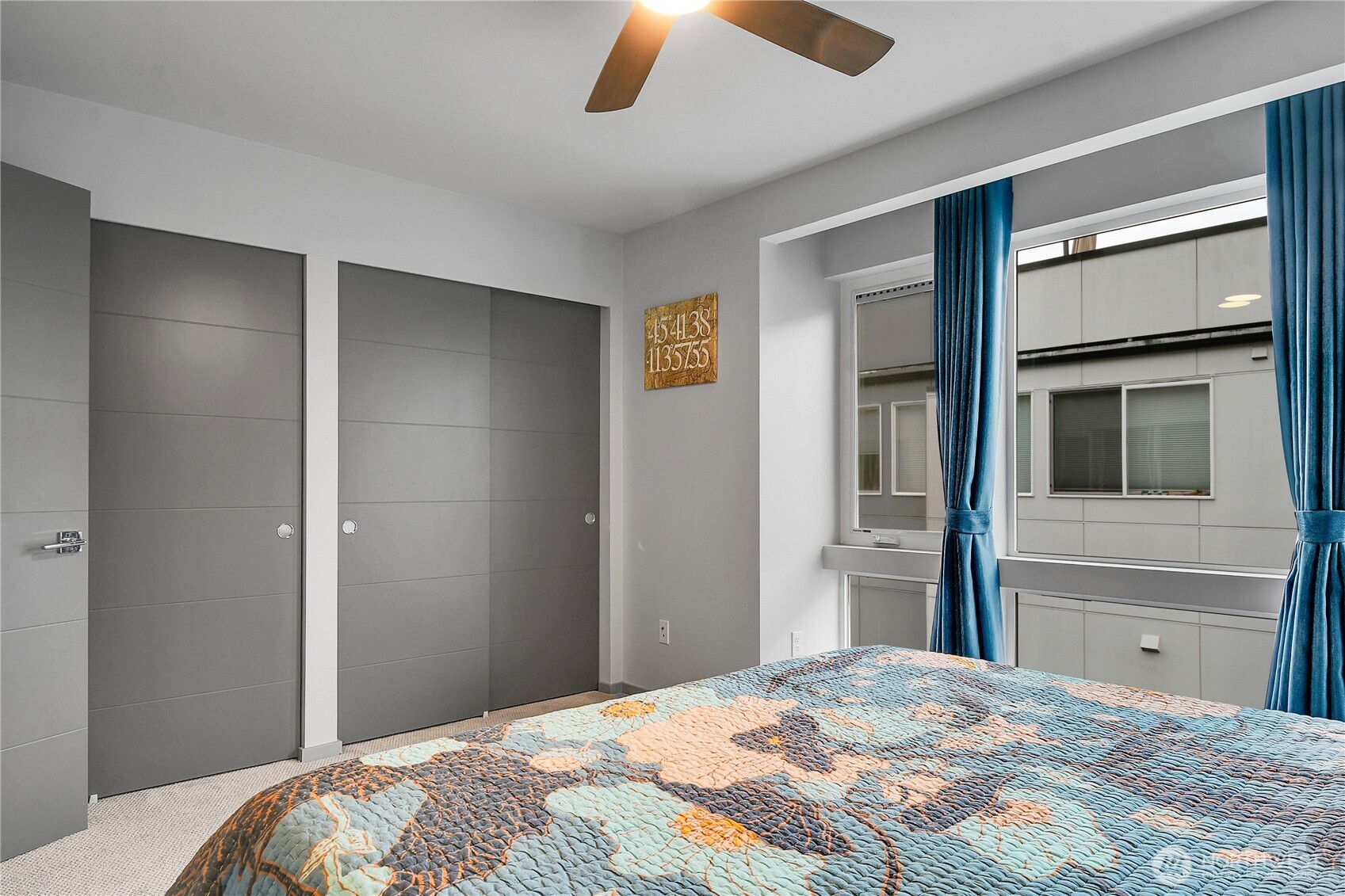 5009 Renton Avenue South, Unit C Seattle, WA 98118 - Photo 14 of 26 a bedroom with a bed and a chandelier
