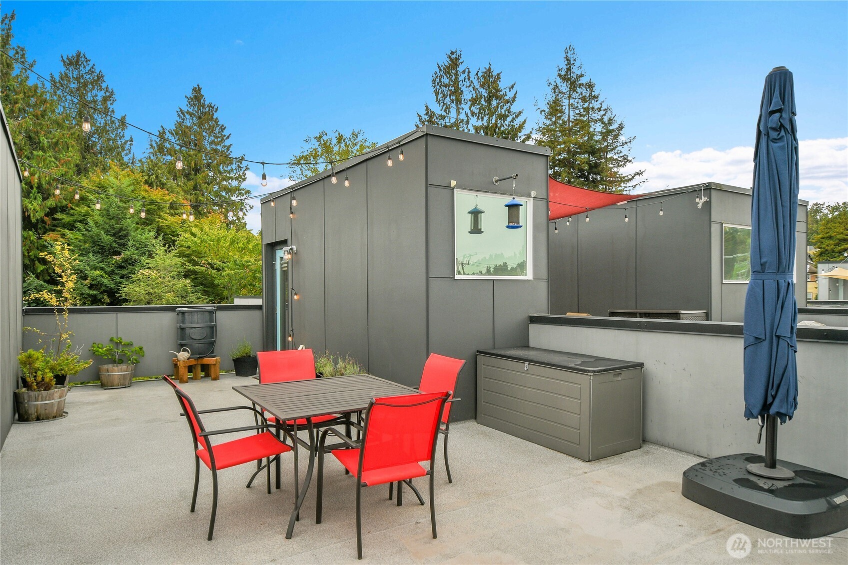 5009 Renton Avenue South, Unit C Seattle, WA 98118 - Photo 18 of 26 a patio with table and chairs and potted plants