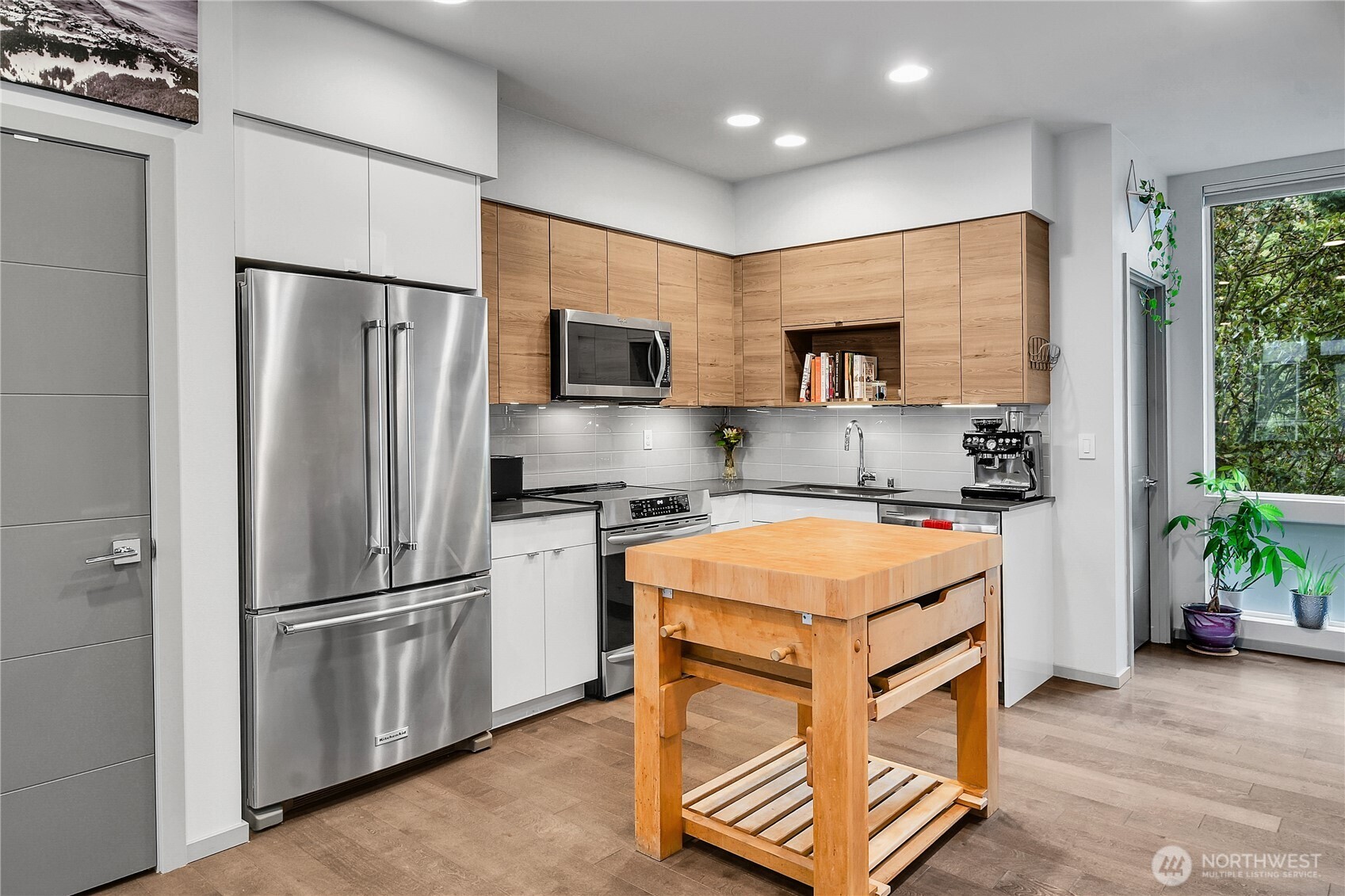 5009 Renton Avenue South, Unit C Seattle, WA 98118 - Photo 6 of 26 a kitchen with stainless steel appliances granite countertop a refrigerator stove and sink