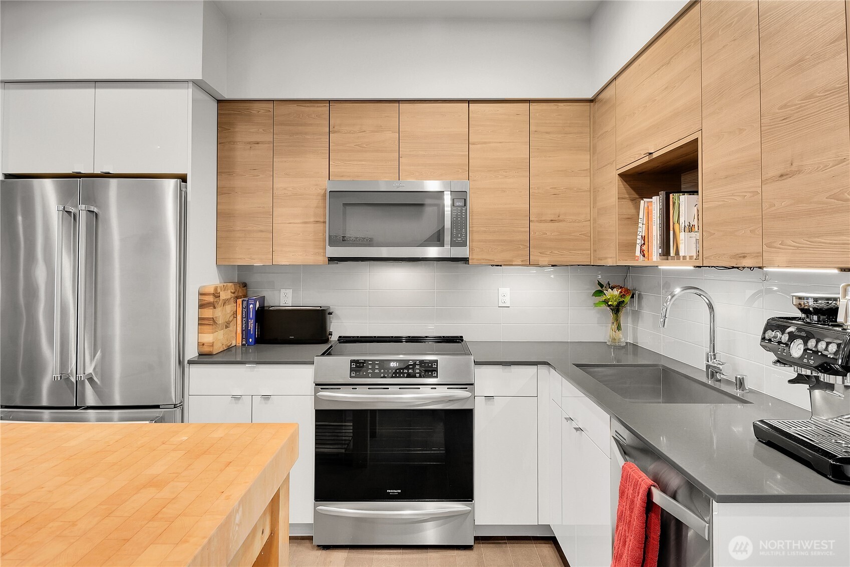 5009 Renton Avenue South, Unit C Seattle, WA 98118 - Photo 7 of 26 a kitchen with stainless steel appliances a stove microwave and sink