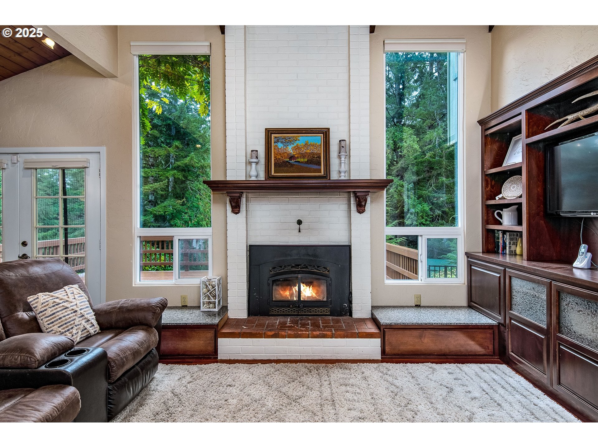 5001 Ford Way Florence, OR 97439 - Photo 12 of 48 a living room with furniture a window and a fireplace