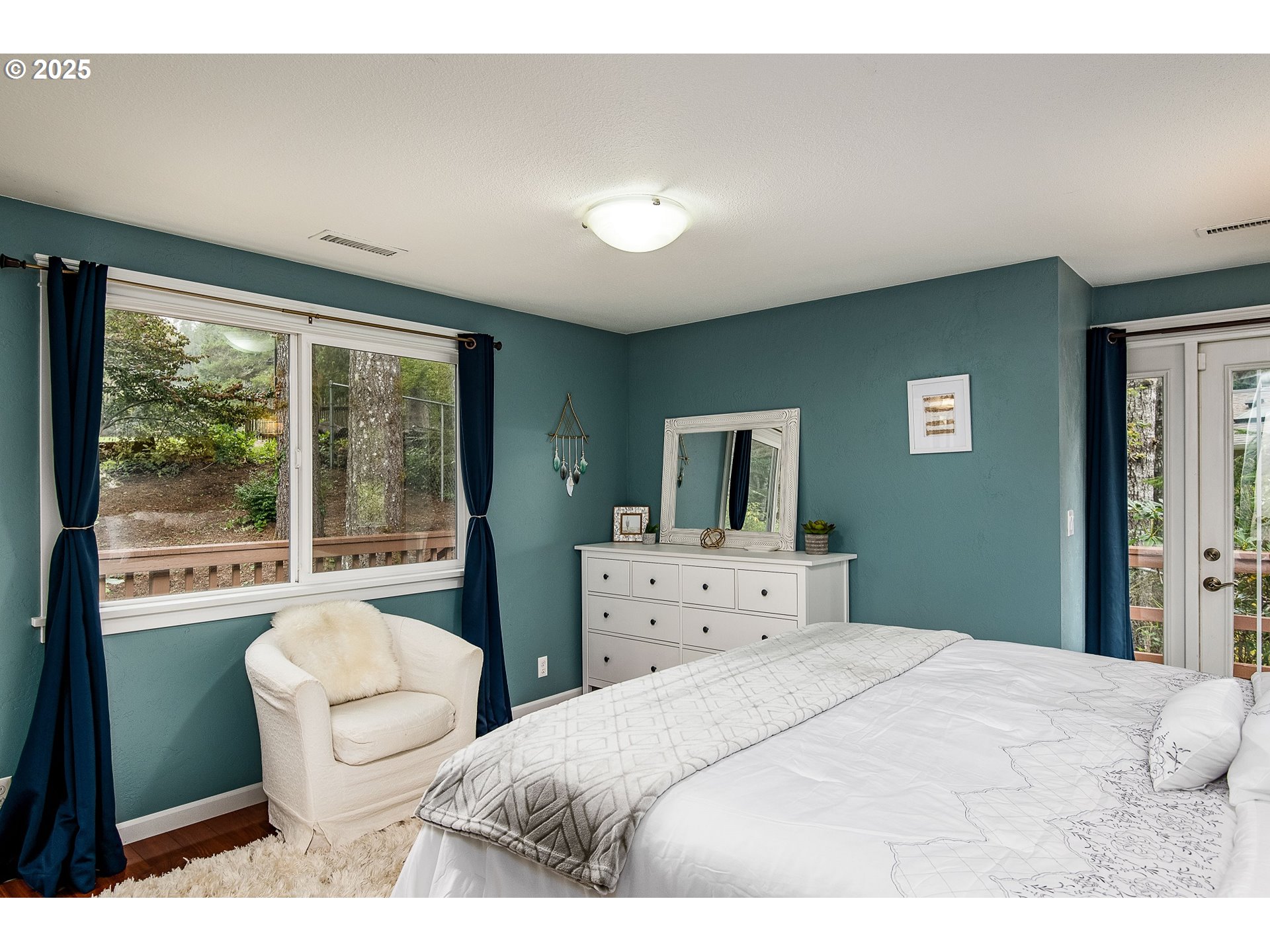 5001 Ford Way Florence, OR 97439 - Photo 19 of 48 a bedroom with a bed and a large window