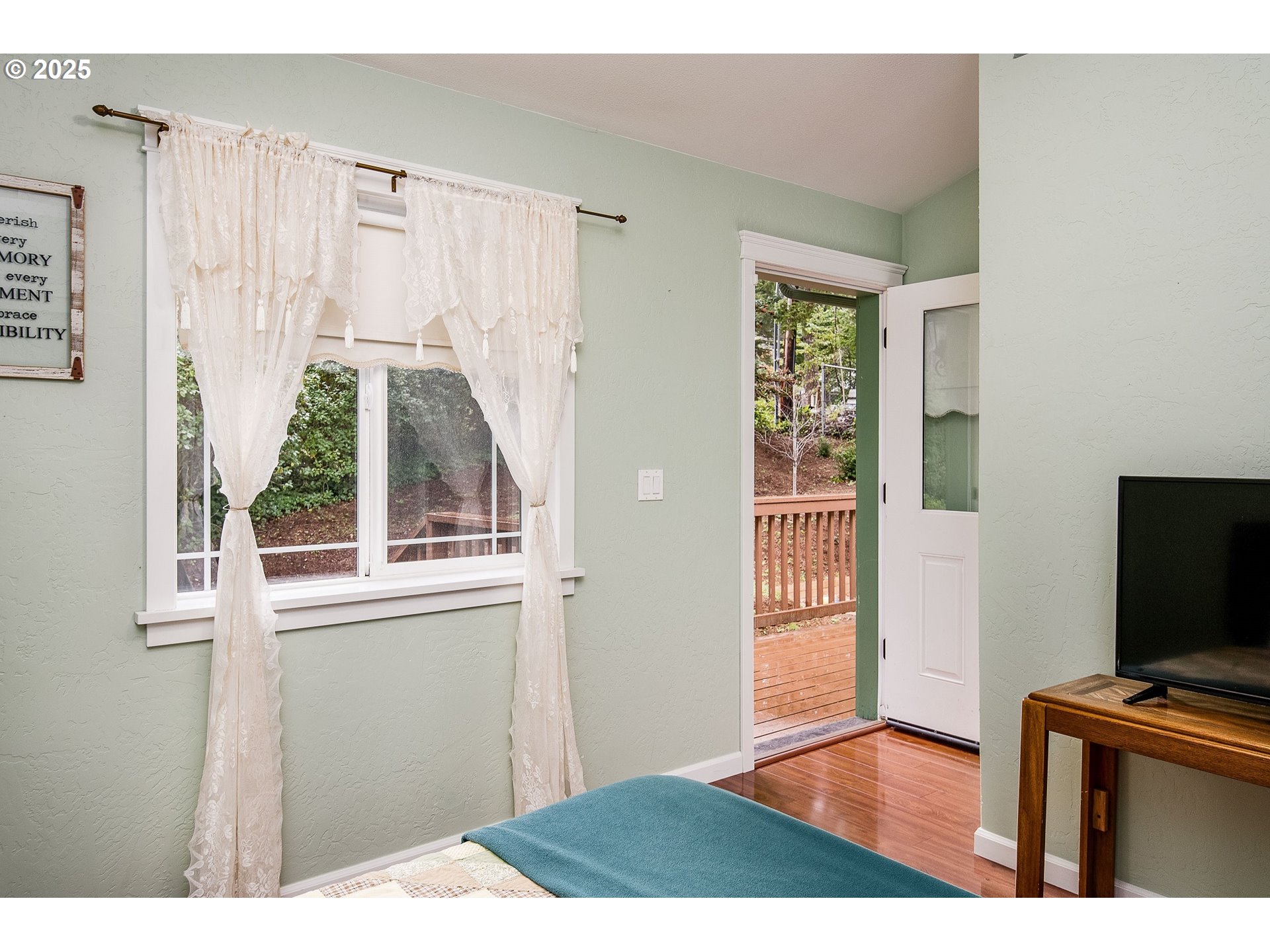 5001 Ford Way Florence, OR 97439 - Photo 37 of 48 a view of a bedroom with wooden floor and windows