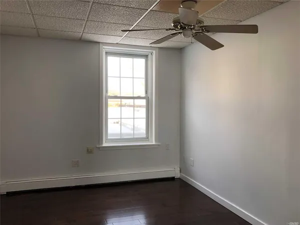 a view of a small space with wooden floor and windows
